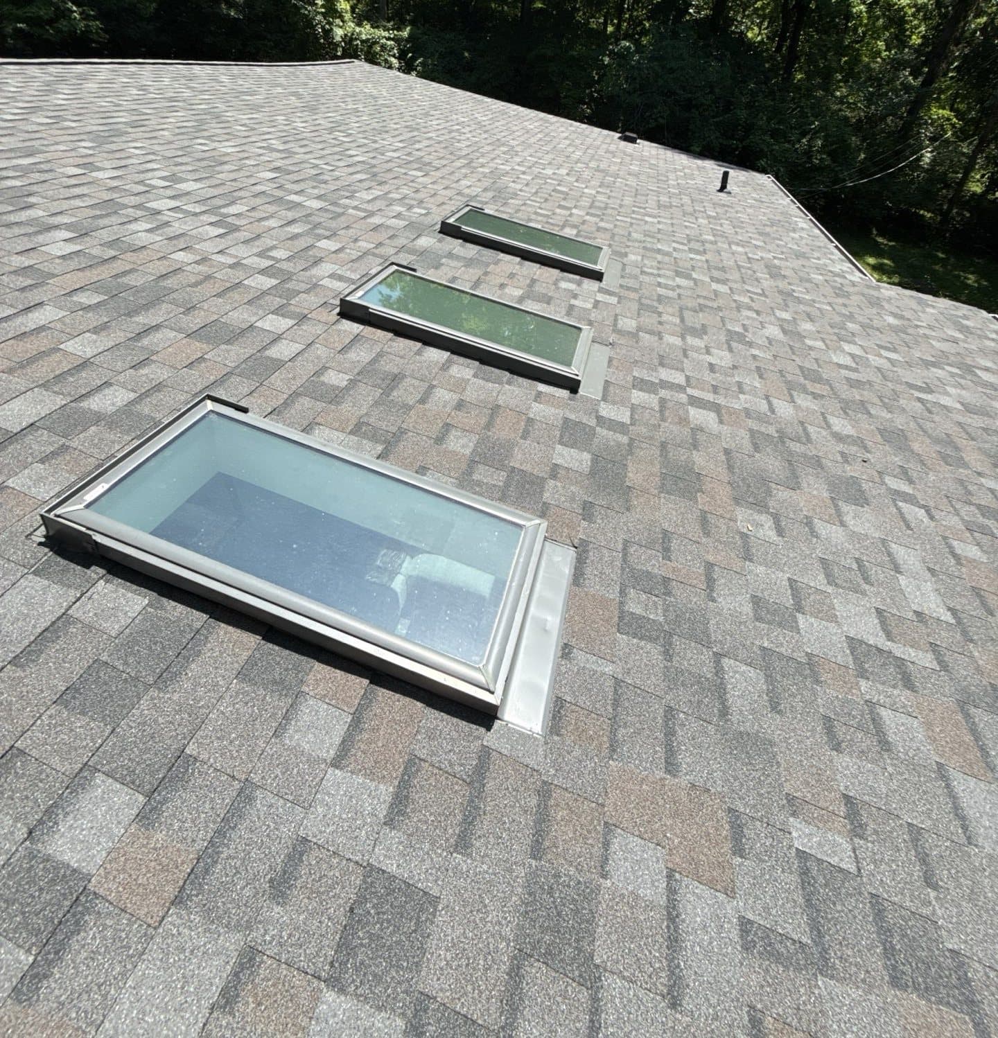 Completed architectural shingle roof with reflashed skylights on a Cincinnati home